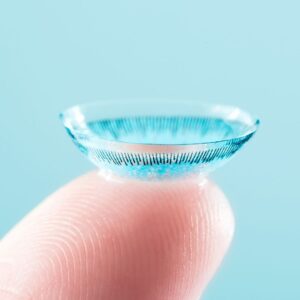 Fingertip holding a contact lens
