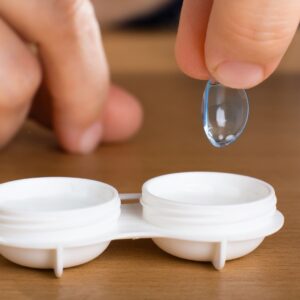 Putting a contact lens into contact lens case