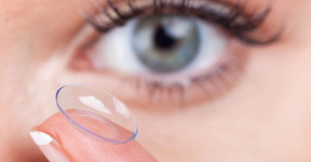 Holding a contact lens in front of an eye