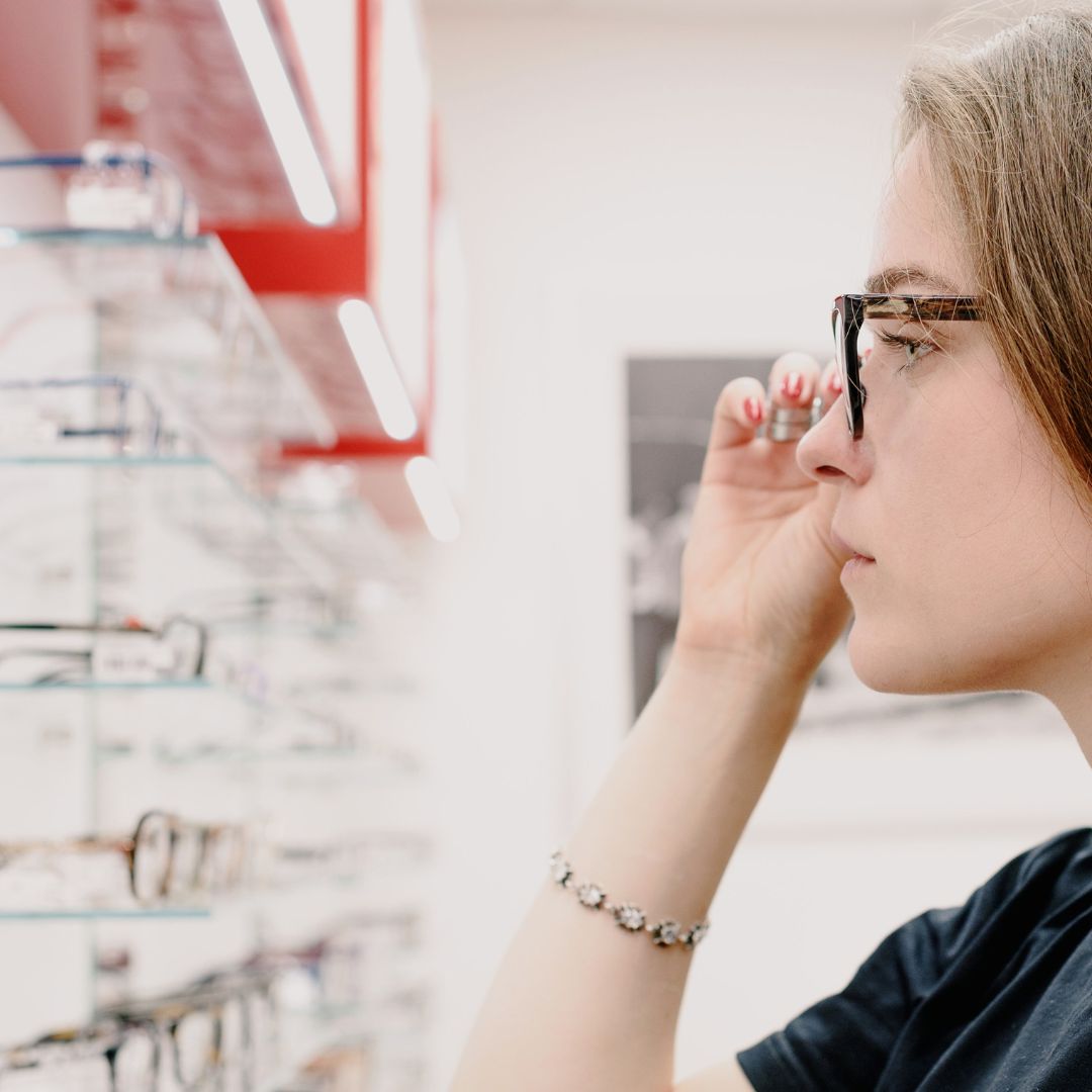 woman wearing glasses shopping for new glasses