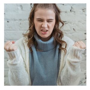 a stressed women with her eyes closed