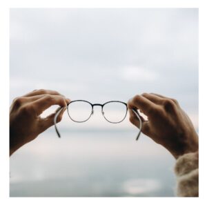 someone putting on their glasses