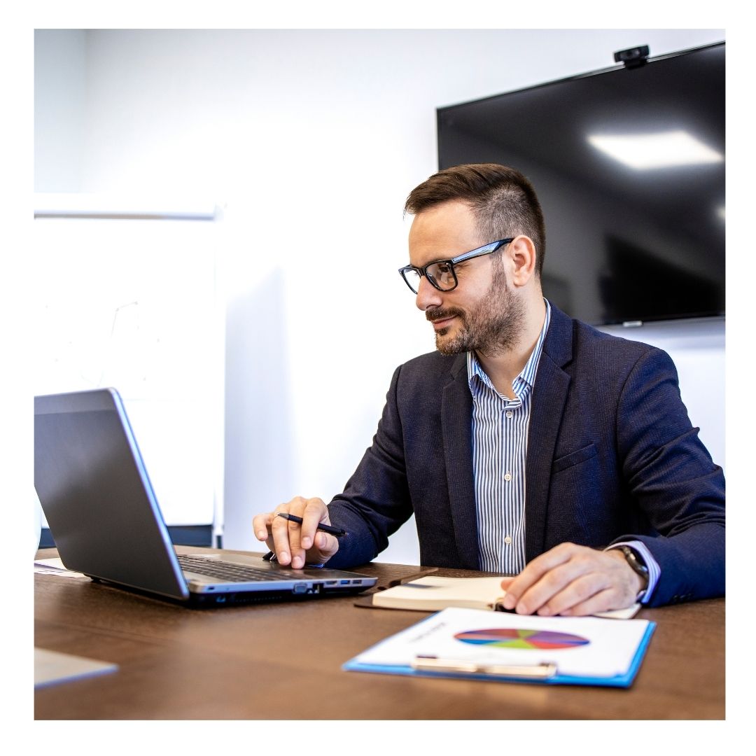man wearing glasses working on computer