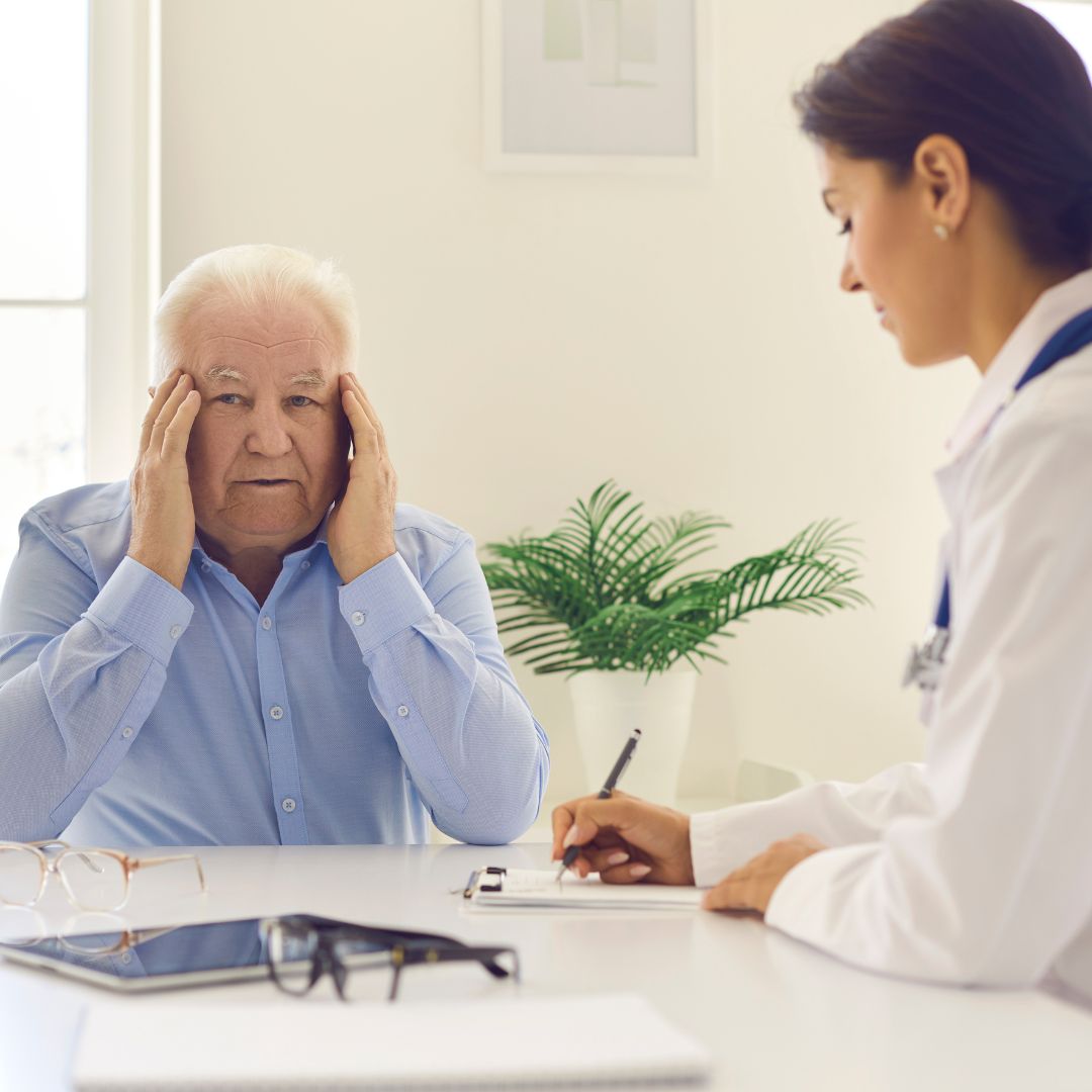 a man rubbing his temples