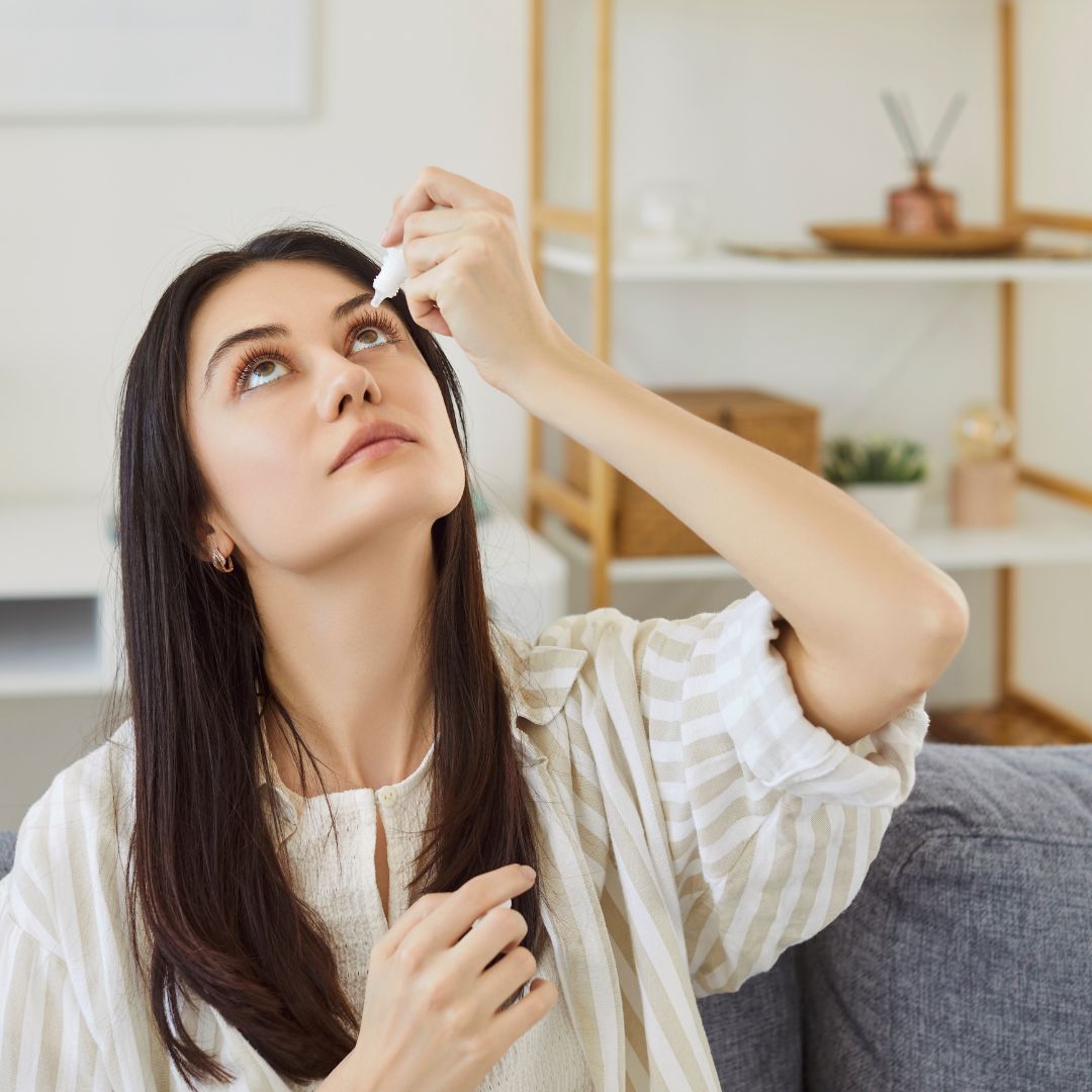 woman putting eye drops in 