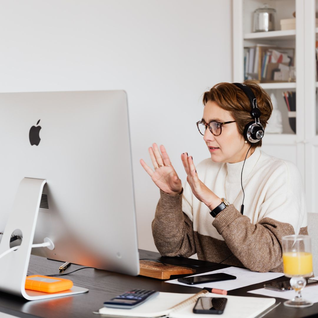 woman wearing glasses working on computer