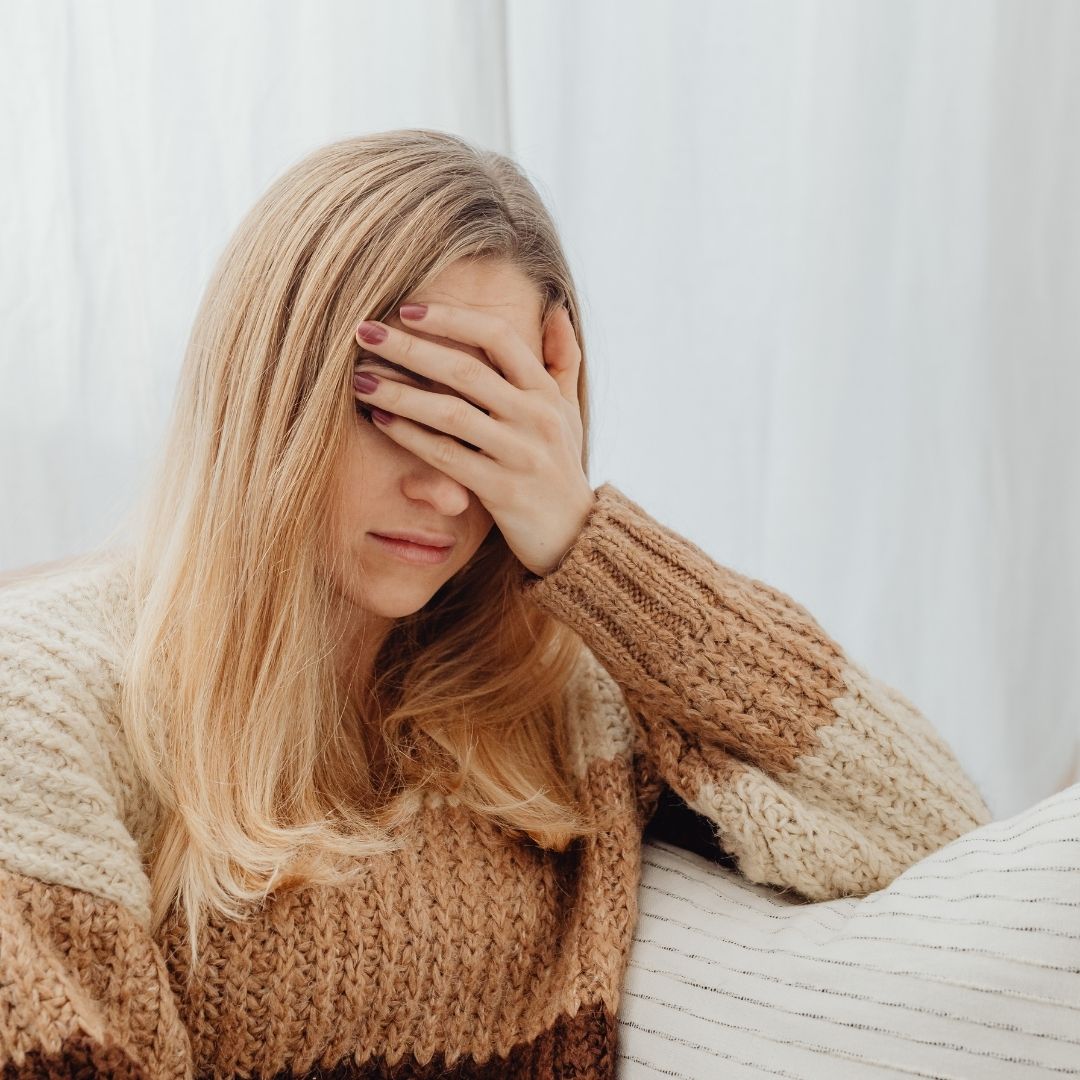 person covering eyes because she is tired